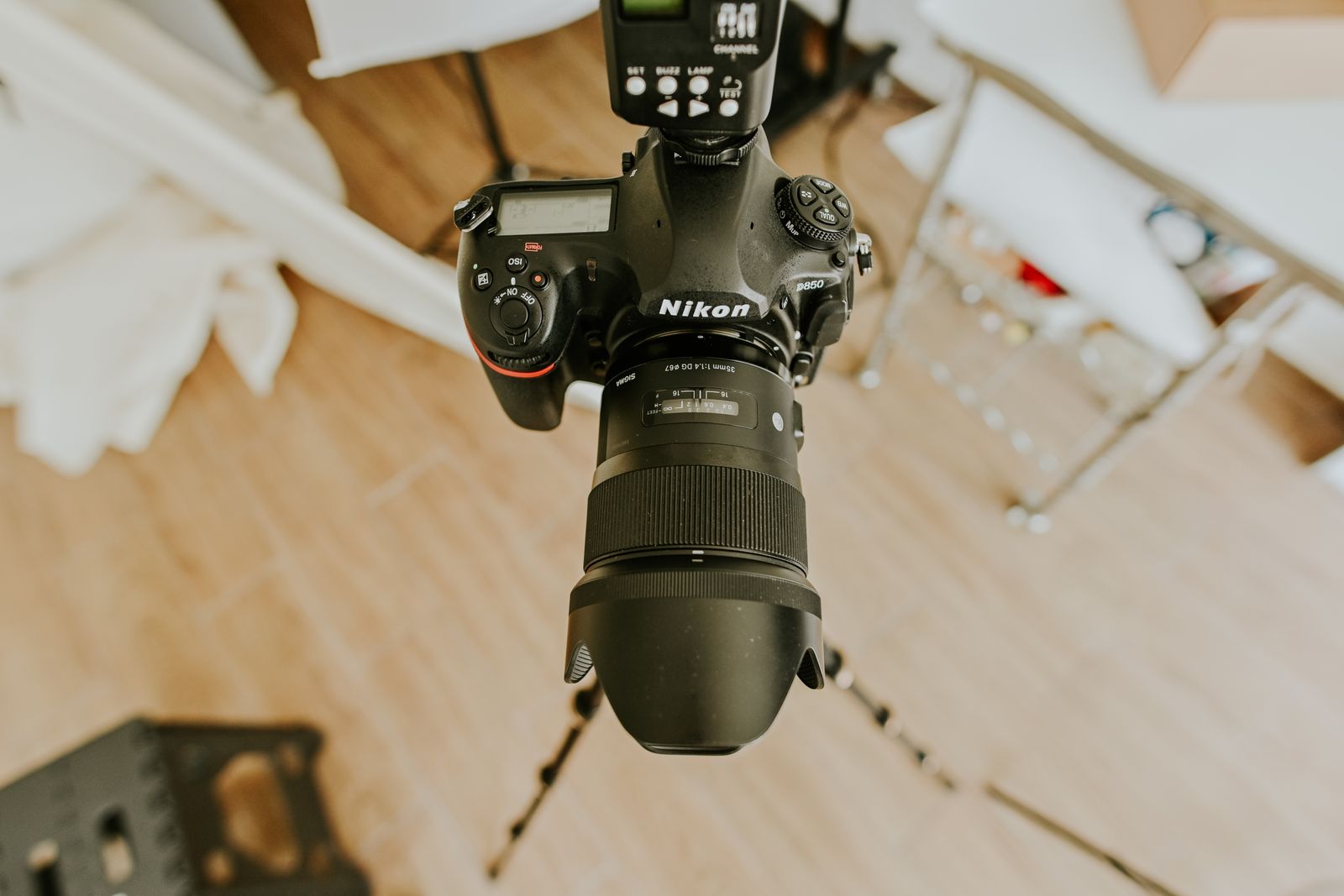 A high-angle view of a professional DSLR camera with a long lens on a tripod
