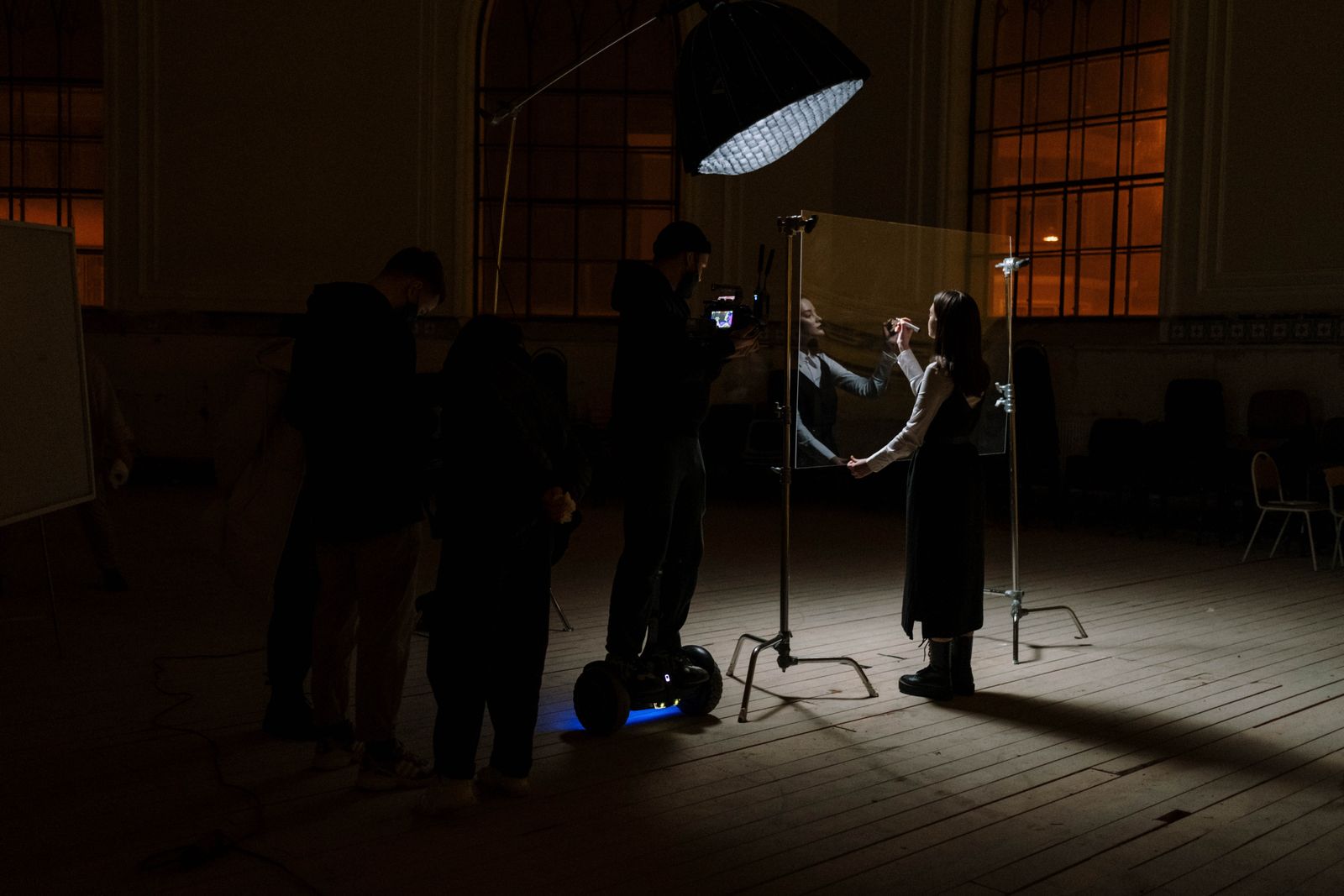 A film crew lighting a dramatic themed set inside a studio