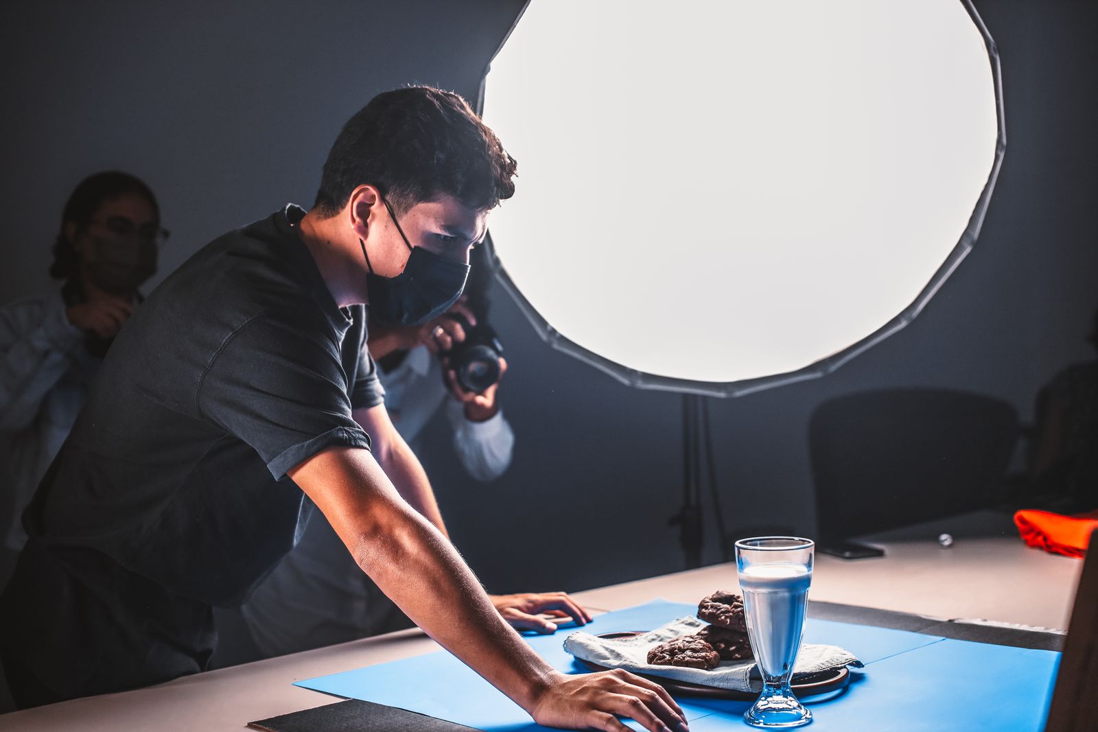 A photographer setting up specialised lighting for a commercial photoshoot