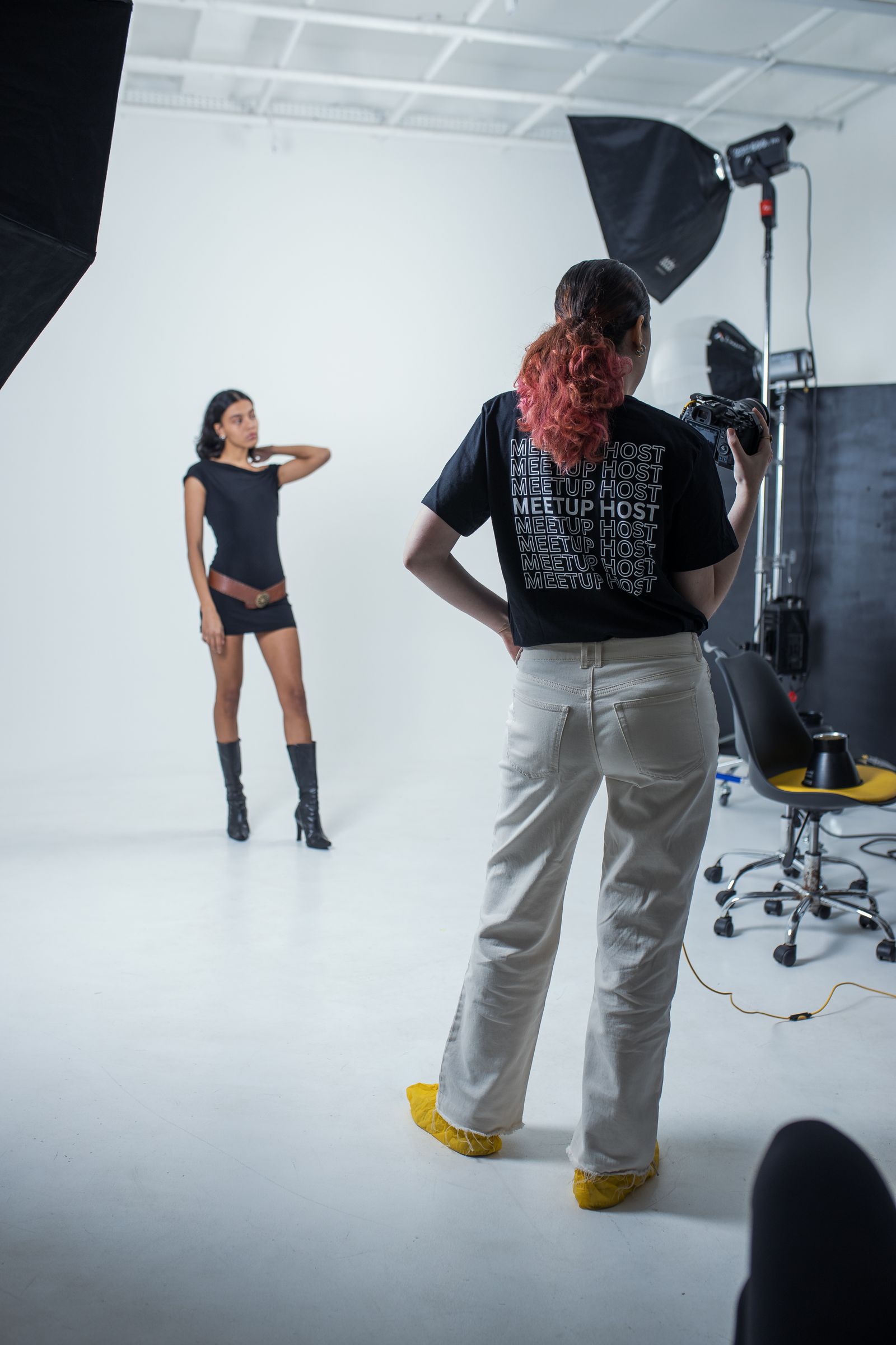 A photographer reviewing a portrait shot on camera during a studio session