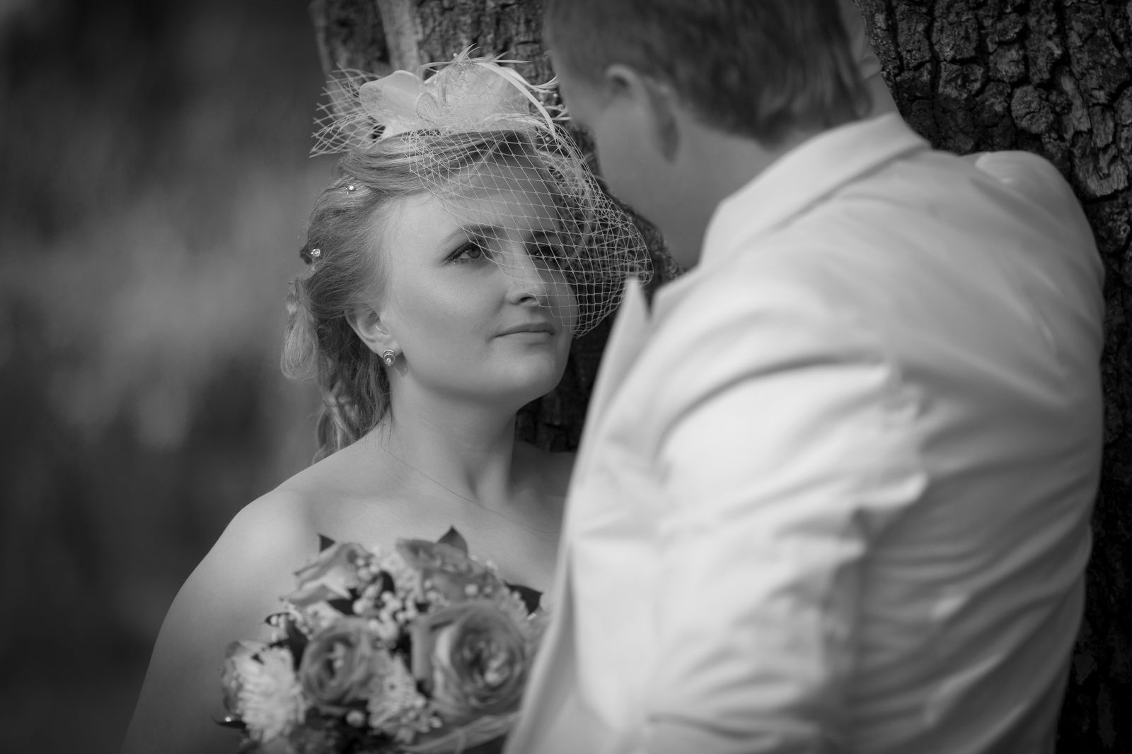 Close-up black and white portrait of a bride and groom
