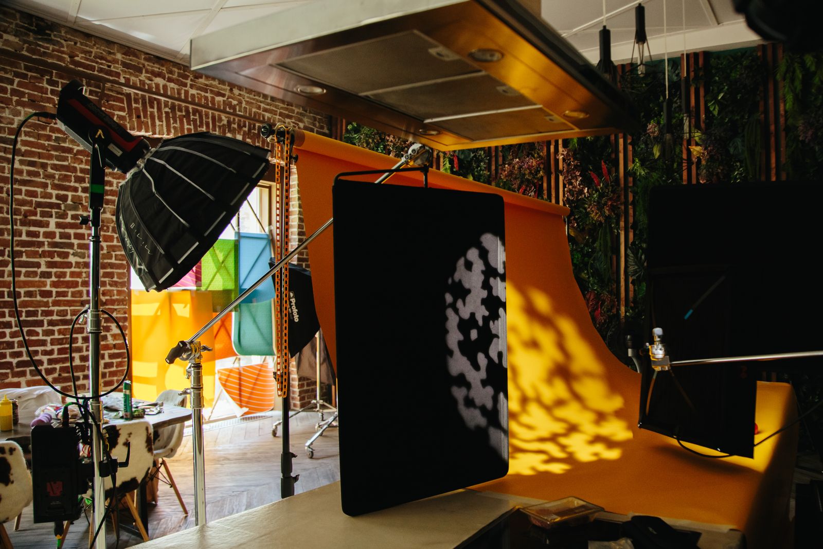 A studio room with exposed brick, coloured backdrops and props built for a themed set